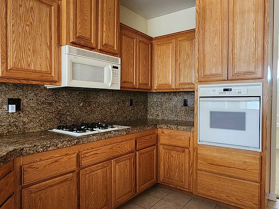 Oak cabinet kitchen with built in for appliances. Granite counter tops!