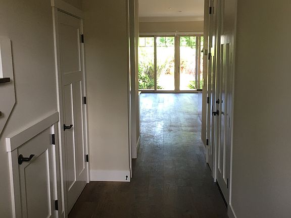 Entry hallway showing storage and laundry room doors on left. Door to garage on right.