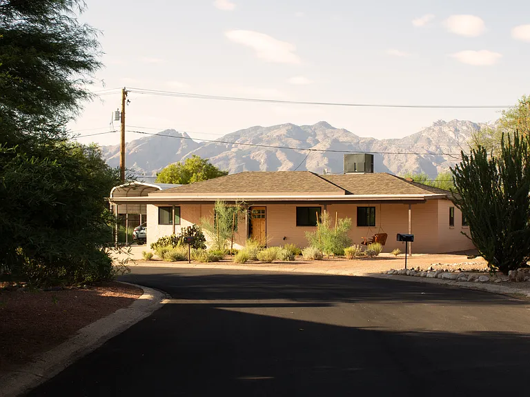 Desert ranch-style home with beautiful mountain backdrop in a quiet residential setting.