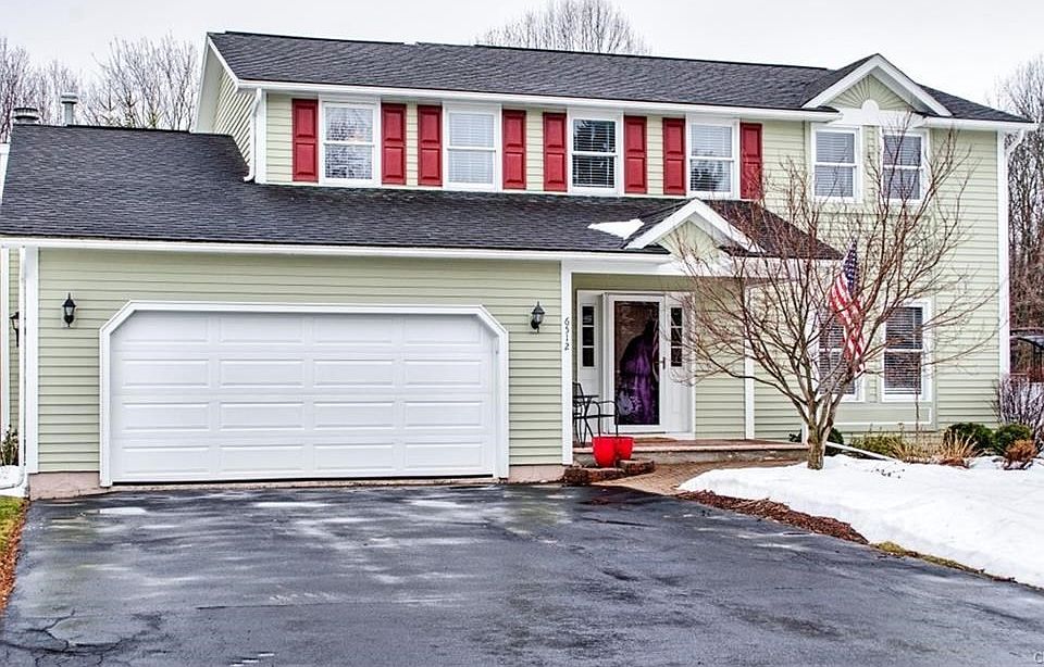 Freshly painted exterior with pavered walkway and front porch.