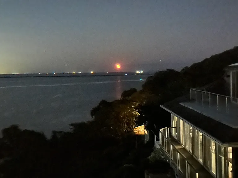 Moonrise- looking past Sandy Hook beach, rising over the fishing boats on the Atlantic Ocean. (The NYC skyline to the left of the frame.)