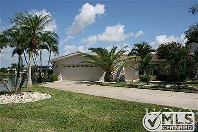 Front of house with water on the back and the left side.