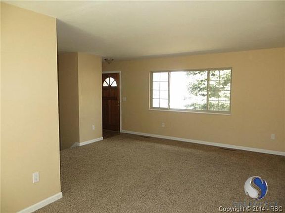 Warm and welcoming. Front entry into living room.