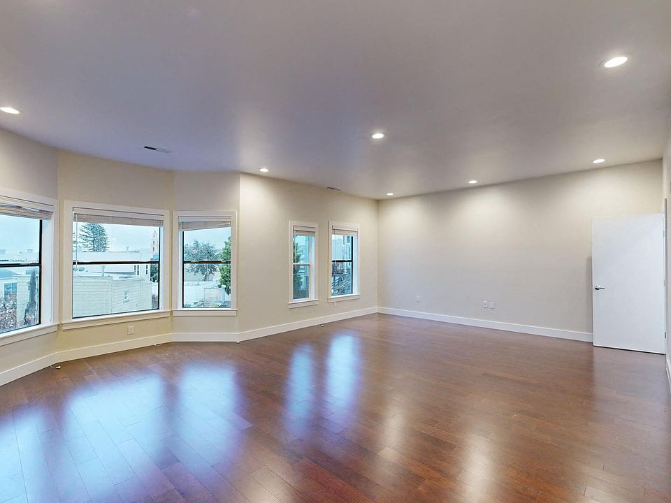 Living area with large windows and wood-like flooring