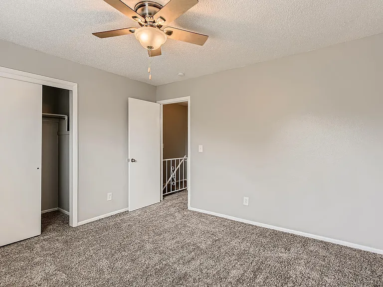 A bedroom with a closet at Alder Square Rental Townhomes