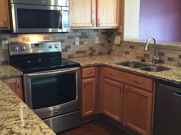 Kitchen with stainless steel appliances and granite counters
