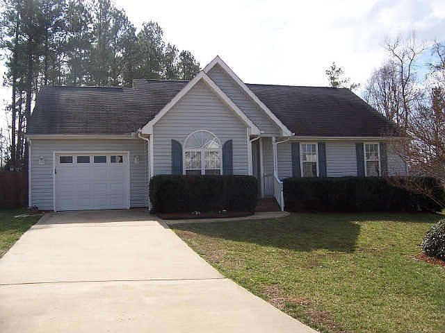 Front of house - nice level driveway and garage