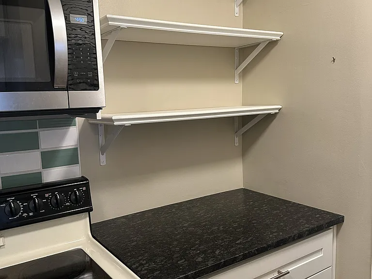 Kitchen, includes stainless steel appliances, dishwasher, microwave, and electric range.
