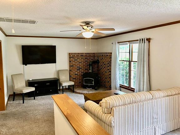 Family room has wood burning stove and large screen TV with roku stick.