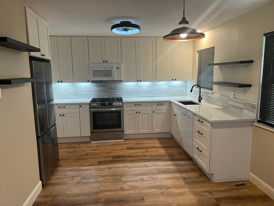 Large eat-in kitchen. Fully remodeled and updated. Lots of cabinet space, pantry and plenty of open shelving . Large gas range. Door to dining area is on the left, and the kitchen is open to the den on the other end. windows overlook the rear patio.