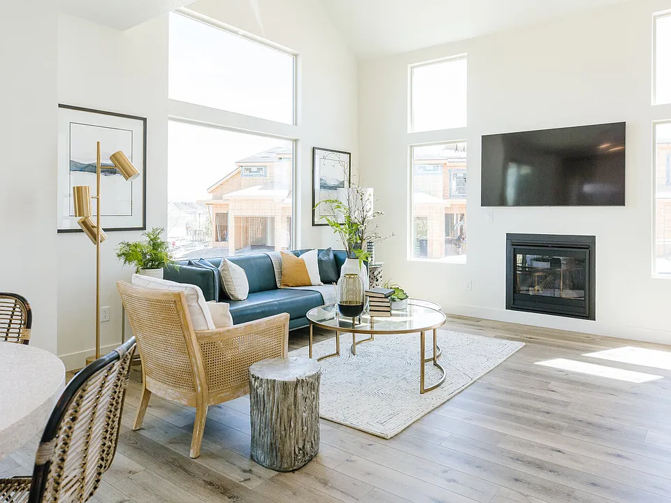 Living space is bright and open with oversized windows and gas fireplace.