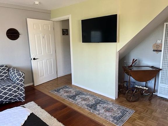 Entrance to the apartment. Flatscreen TV and Tea cart.