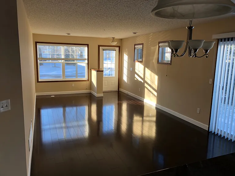 Bright living and dining area with large windows and beautiful afternoon and evening sunlight.