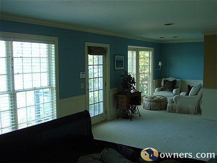 Master Bedroom w/ balcony and sitting area overlooking lake