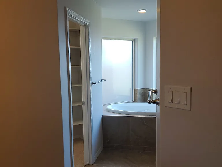 En suite bathroom features double sinks, walk in shower and soaking tub.