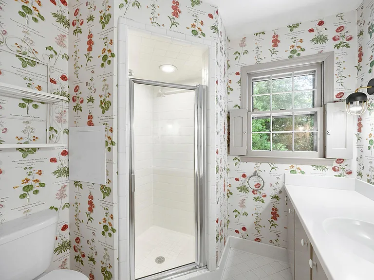 Ensuite bathroom with built-in shelving and a clean, simple layout for easy daily use.