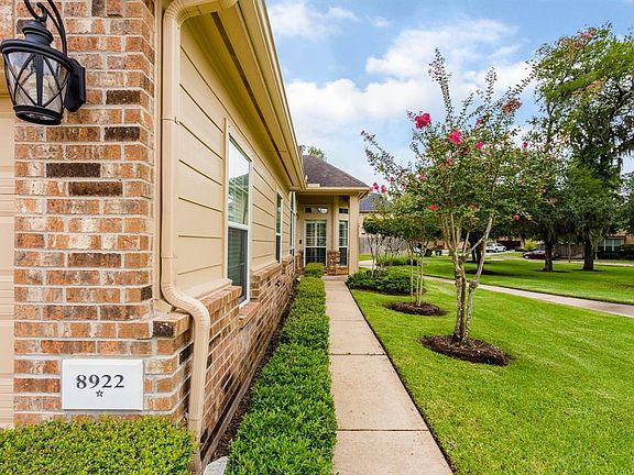 Guests will enter the home by this walkway that enjoys views of the lovely landscaping and park. A/C, Ductwork, Furnace and Tankless Water Heater were replaced in 2016.