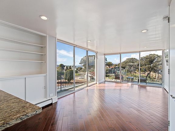 Spacious, open living/ding space with floor to ceiling windows and great light.