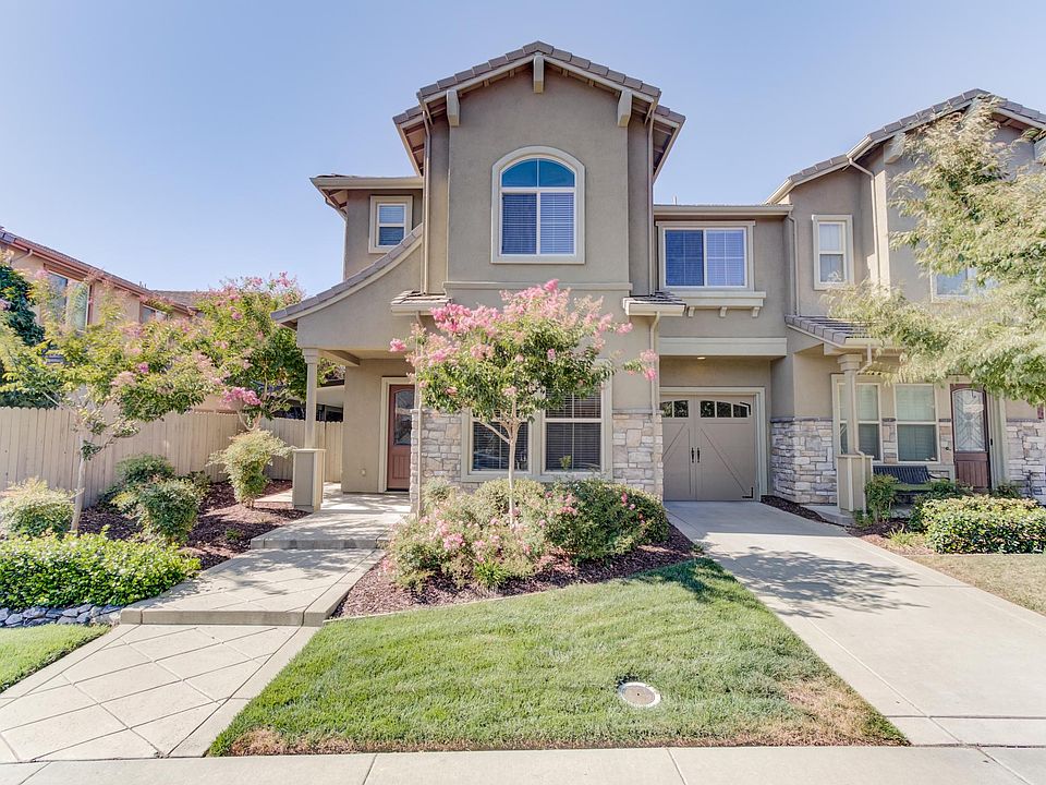 Front of home. Two car tandem garage with elongated driveway.