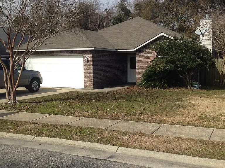 Sidewalk view, home and garage. Fenced boat parking if needed just to left of garage. Private courtyard to right, fenced.
