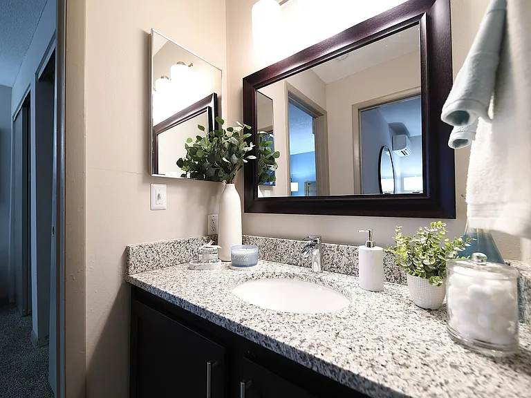 Immerse yourself in elegance with this chic bathroom design, featuring a sleek granite vanity.