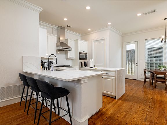 Modern kitchen with a sleek breakfast bar and premium finishes.