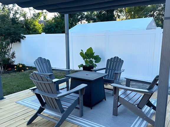 Gas fire pit under pergola, new decking.