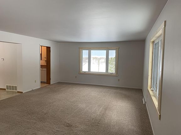 Large living room overlooking the lake. Brand new windows throughout.