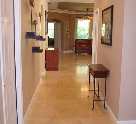 Enter, from foyer throughout home Travertine floor tile, except bedrooms, engineered wood flooring.