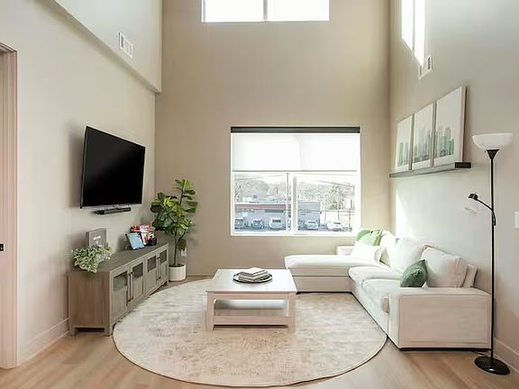 Open concept kitchen + living room with lots of natural light