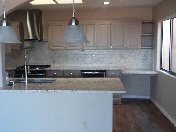 Open dining and kitchen areas with skylights. Wine refrigerator.