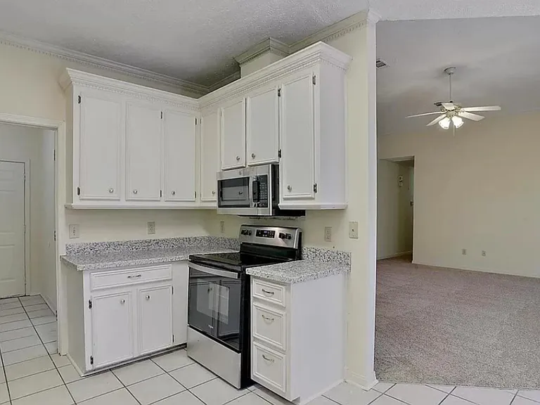 Kitchen view into family room. Door to garage. Lots of cabinets & new appliances