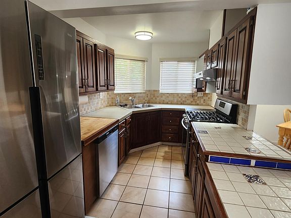 Kitchen has a 4-door refrigerator, and Samsung range and oven.