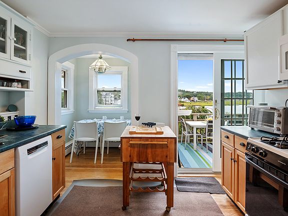 Fully equipped kitchen with an additional breakfast bar and access to the private balcony.