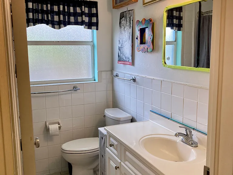 Shining clean bathroom with new acrylic tub/shower surround.