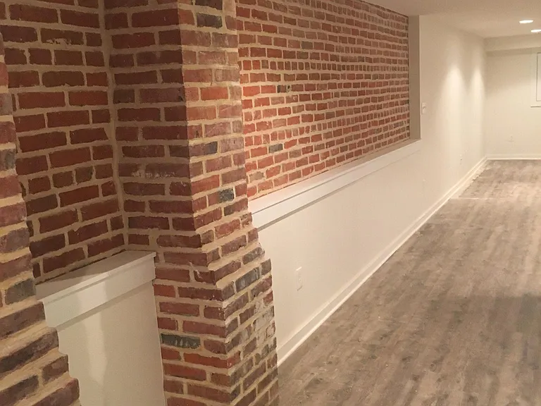 Detailing of built-in bookshelf and exposed brick.
