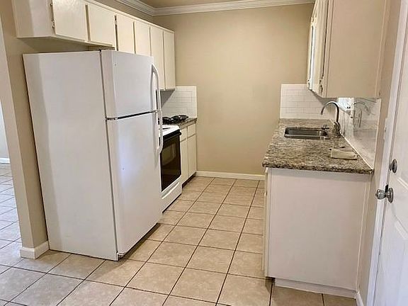 Kitchen has stove/oven, dishwasher and refrigerator.