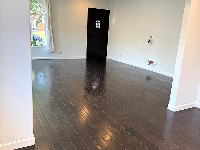 Bright living room filled with natural light, dimmable recessed LED lighting, and pre-wired for TV.