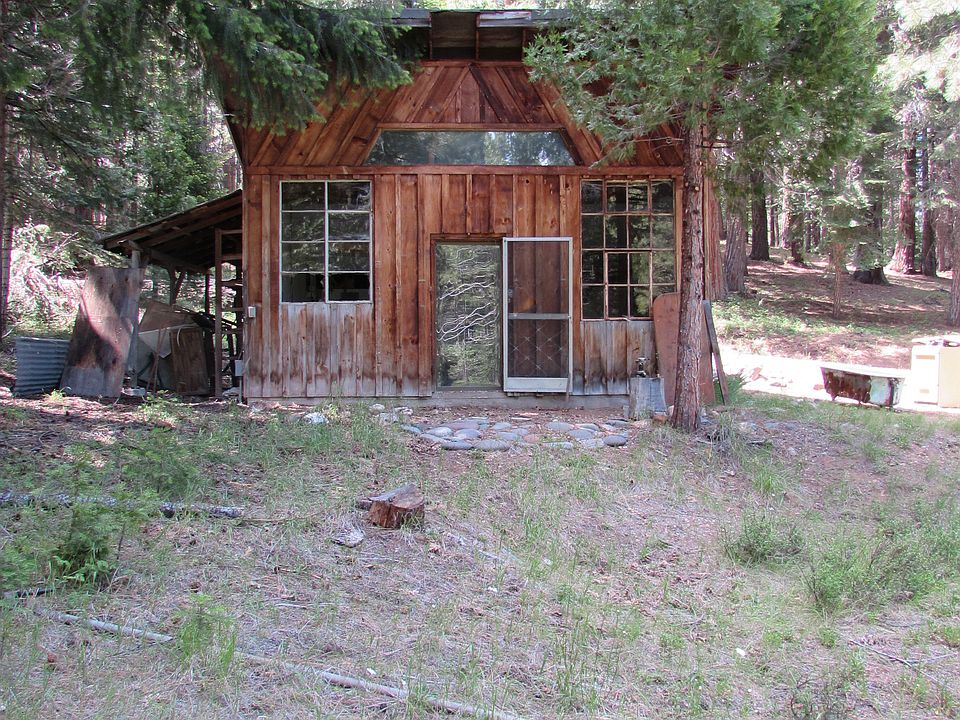 Rustic cabin above pond