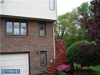 Garage with auto door opener and driveway for two vehicles