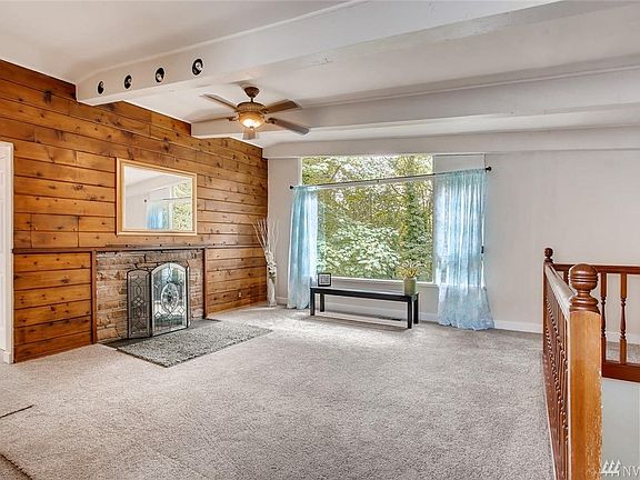 Living room with real wood fire place and brand new wall to wall carpet. Come on in and enjoy the view through the over sized window.
