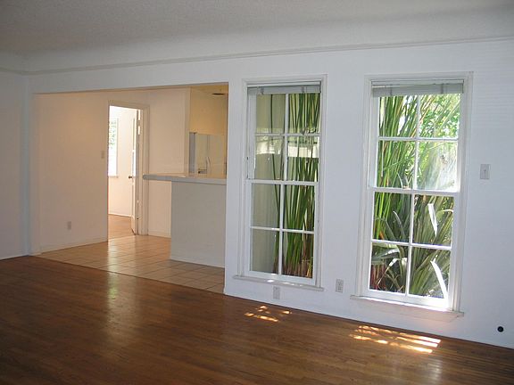 Living room from near front door. Windows overlook garden space between units.