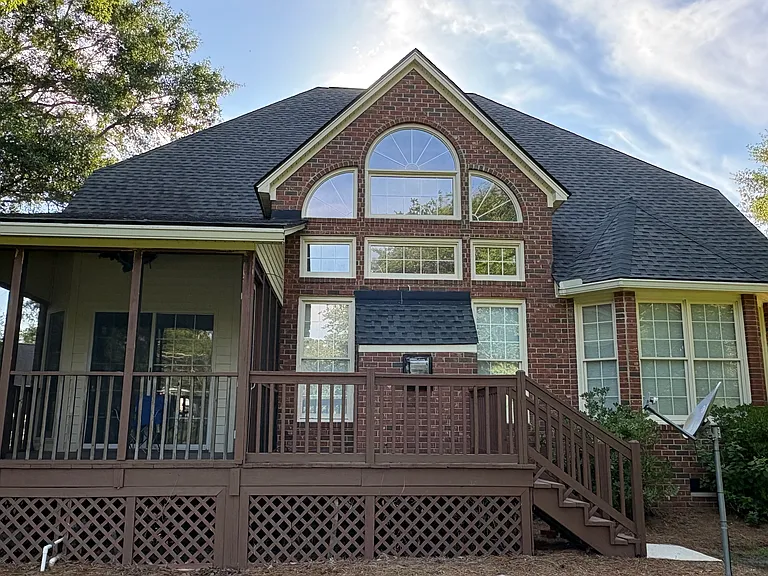 The back of the house shows the screened porch just behind it the breakfast noon. To the right of the porch is the deck, just behind the family room.