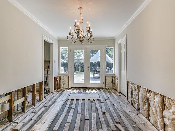 The Formal Dining Room has crown molding and leads to the kitchen.