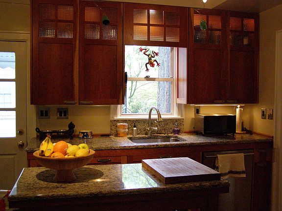 Rolling island in kitchen with granite countertops, Grohe faucet, Bosch DW