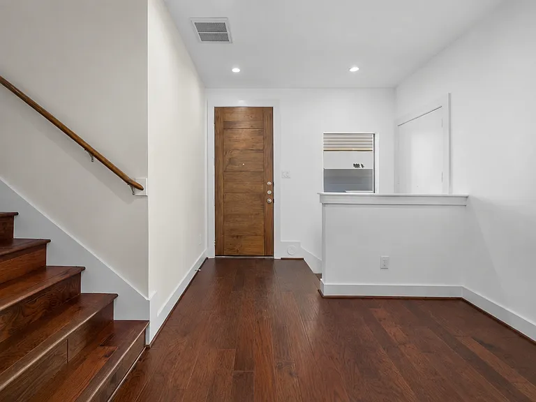 Entrance (front door) with stairs leading to second floor, the living area.