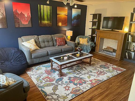 Living room. The fireplace is fake and removed.