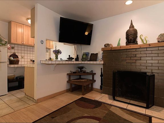 living room with open view to kitchen, breakfast bar and fir