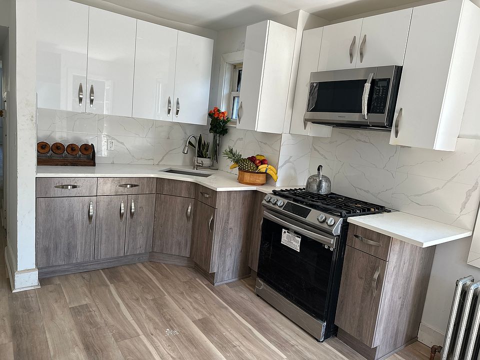 Freshly renovated kitchen, new stainless steel Samsung appliances, side by side refrigerator, new stove, new floors.