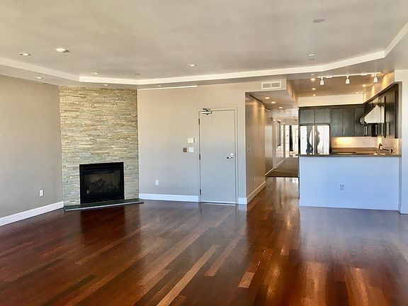 living room with gas fire place connecting to open kitchen